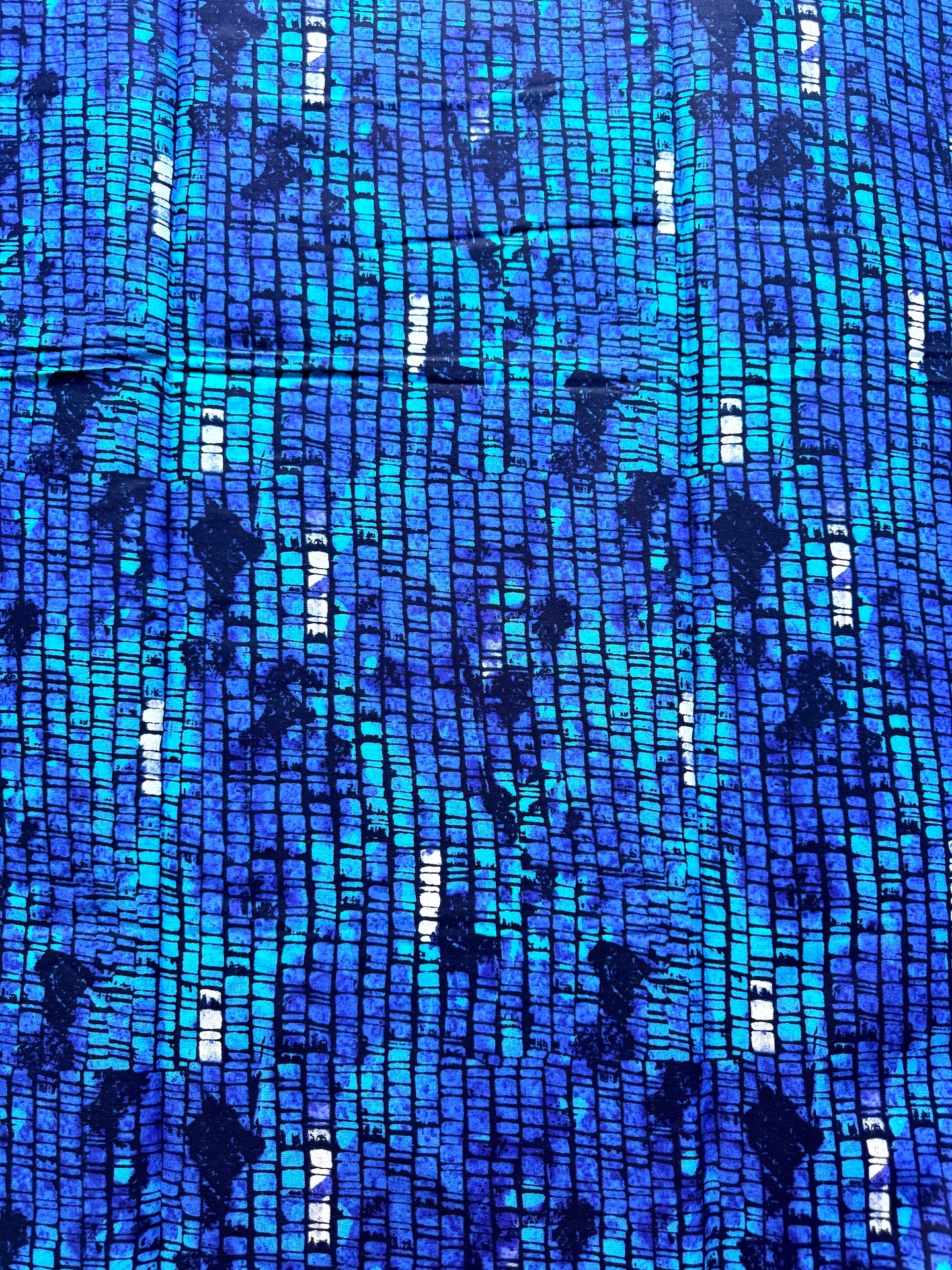Blue fabric with a pattern of small, rectangular shapes