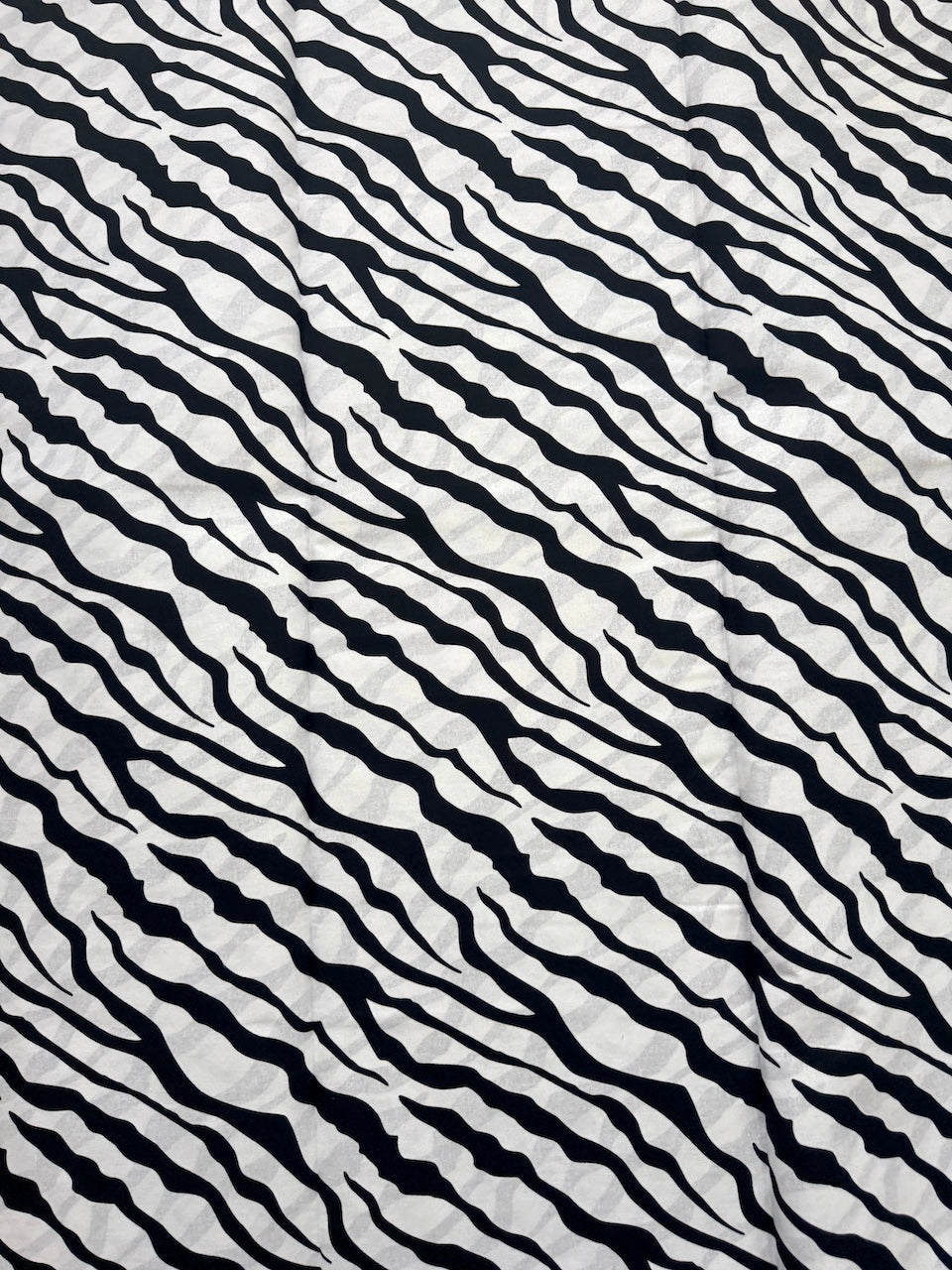 Black and white wavy pattern on a textured background