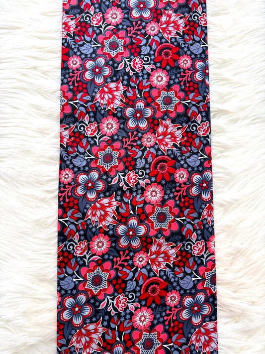 Floral patterned fabric with red and blue flowers on a white fluffy surface
