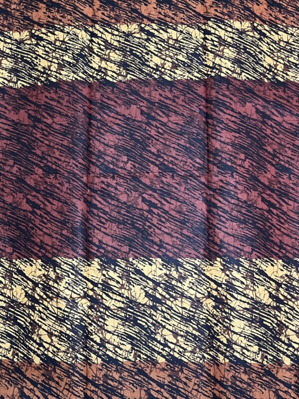 Textured fabric with a pattern of red, black, and gold.