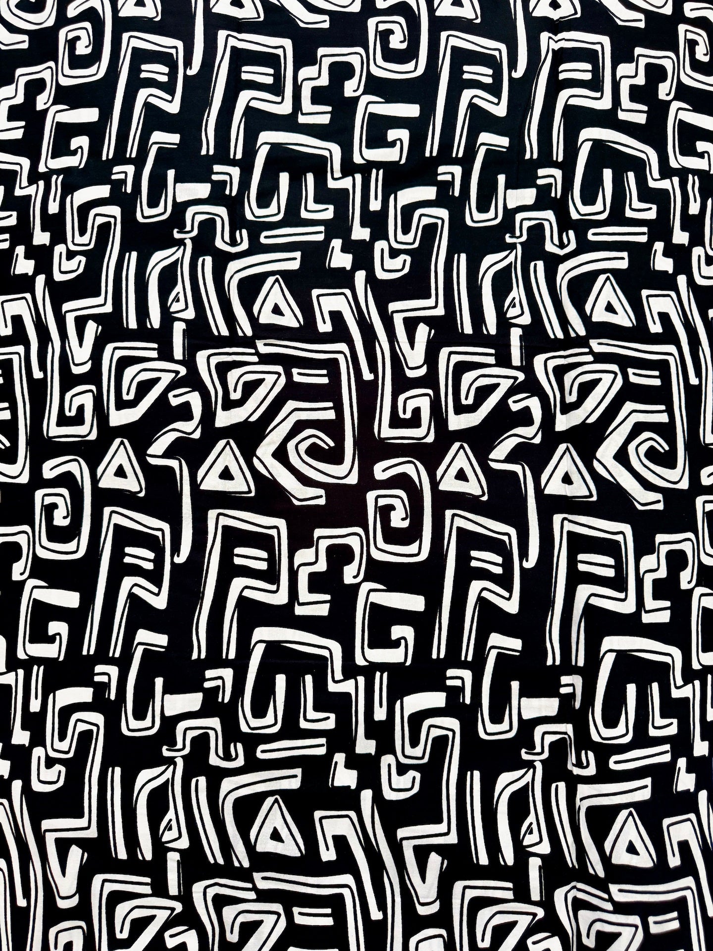 Black and white geometric pattern on a black background