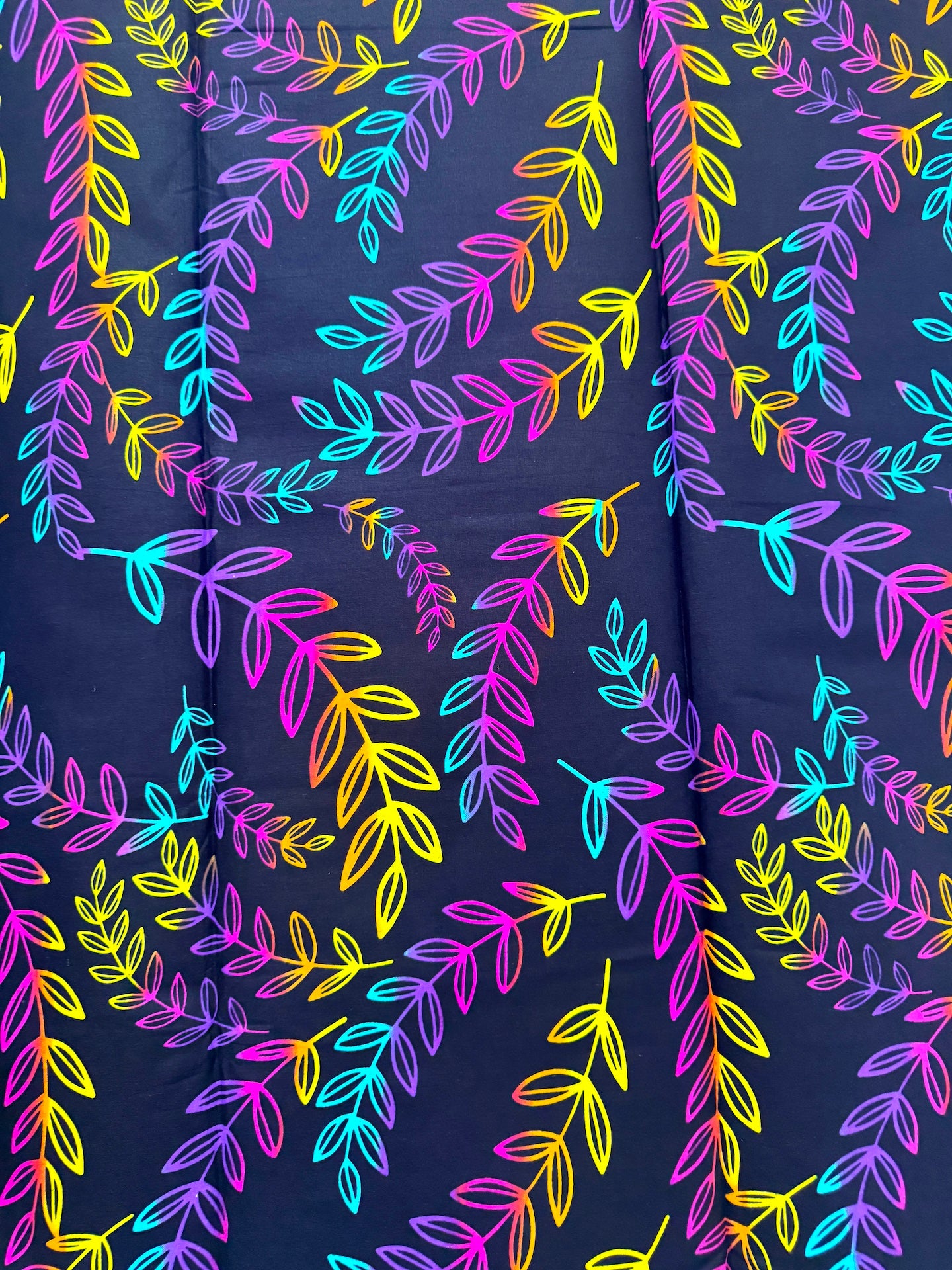 Navy blue fabric with colorful leaf pattern
