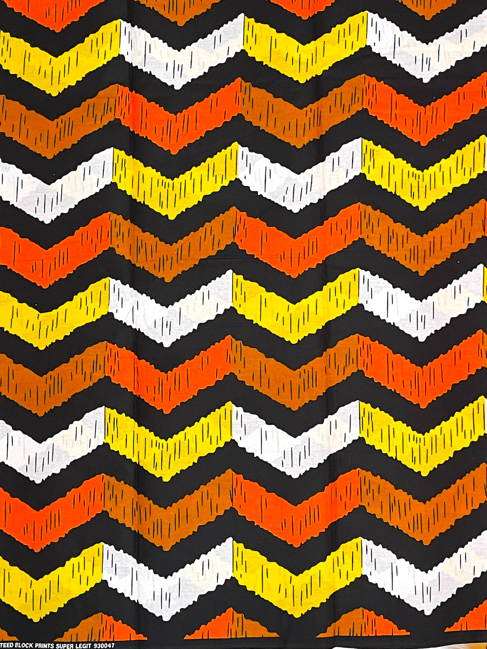 Zigzag pattern with black, orange, yellow, and white lines on a black background