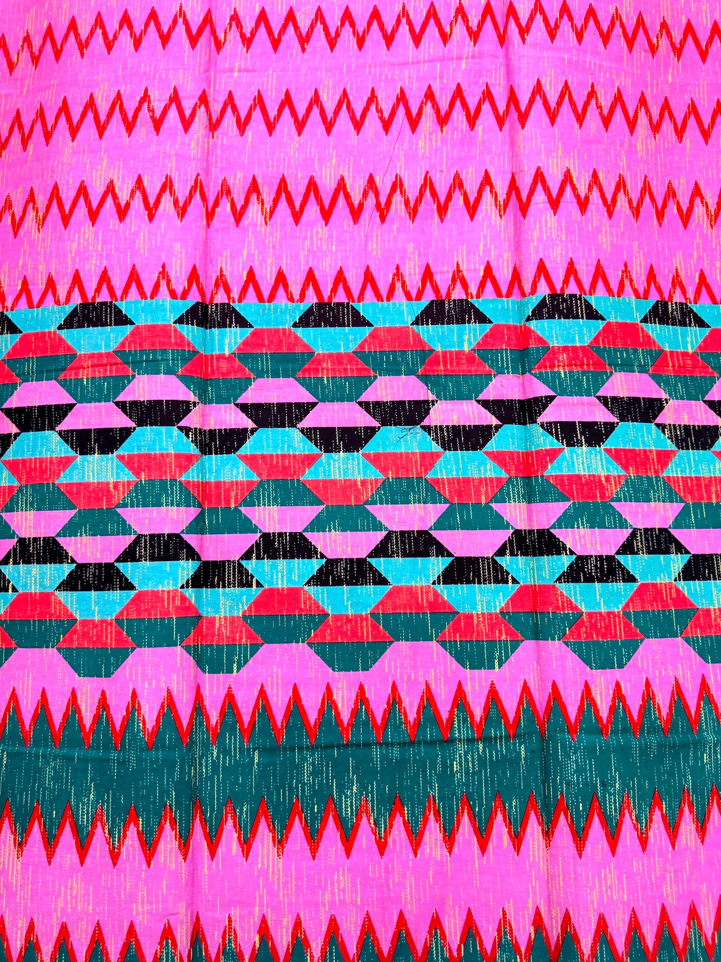 Colorful geometric pattern with zigzag and diamond shapes on a pink and green background.