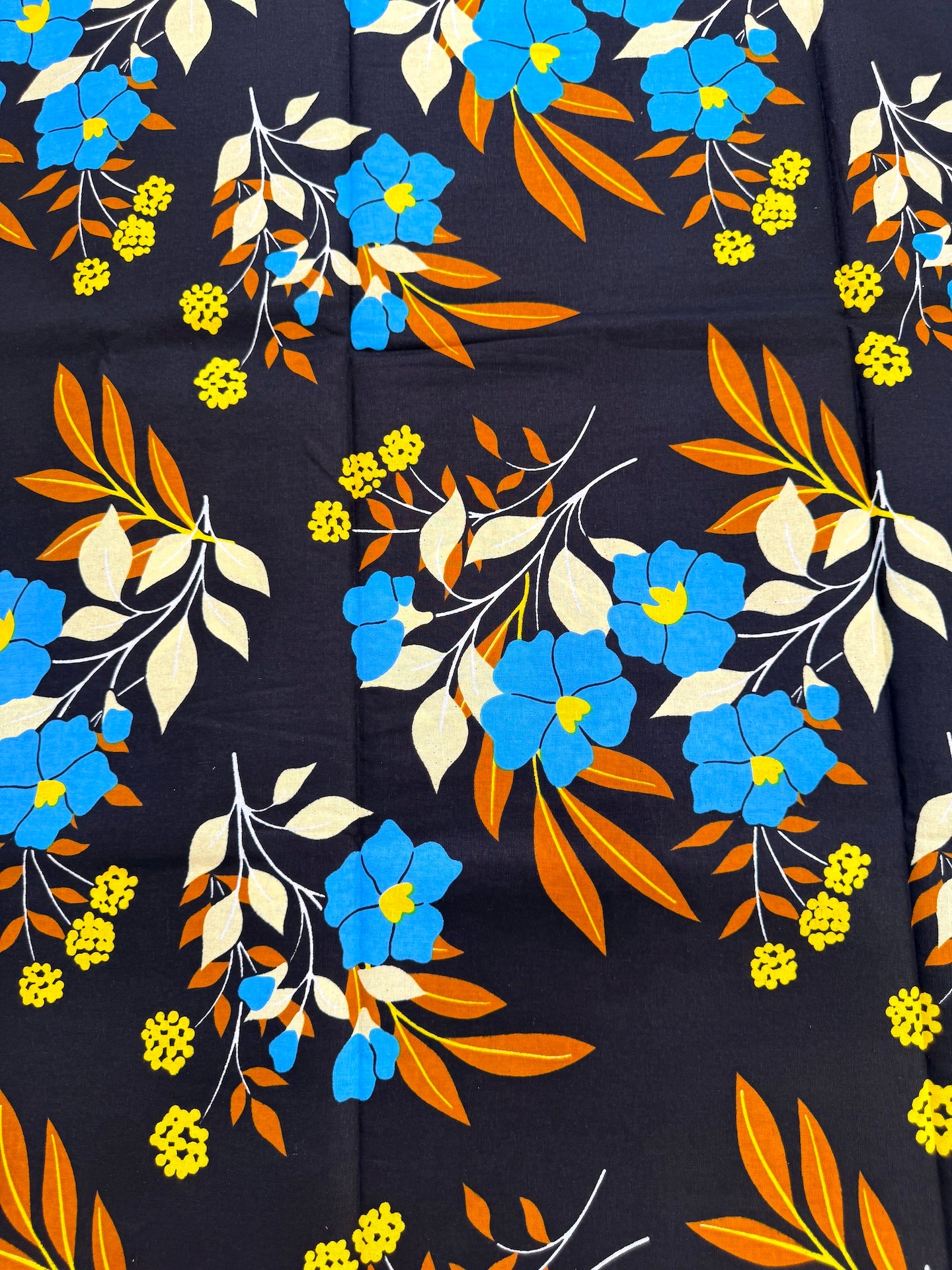 Floral pattern with blue, orange, and yellow flowers on a dark background