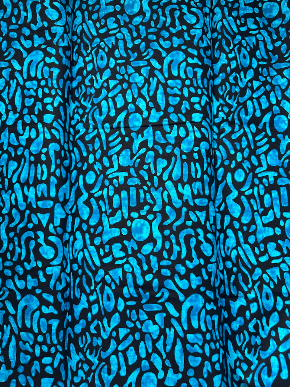 Blue abstract pattern on black fabric