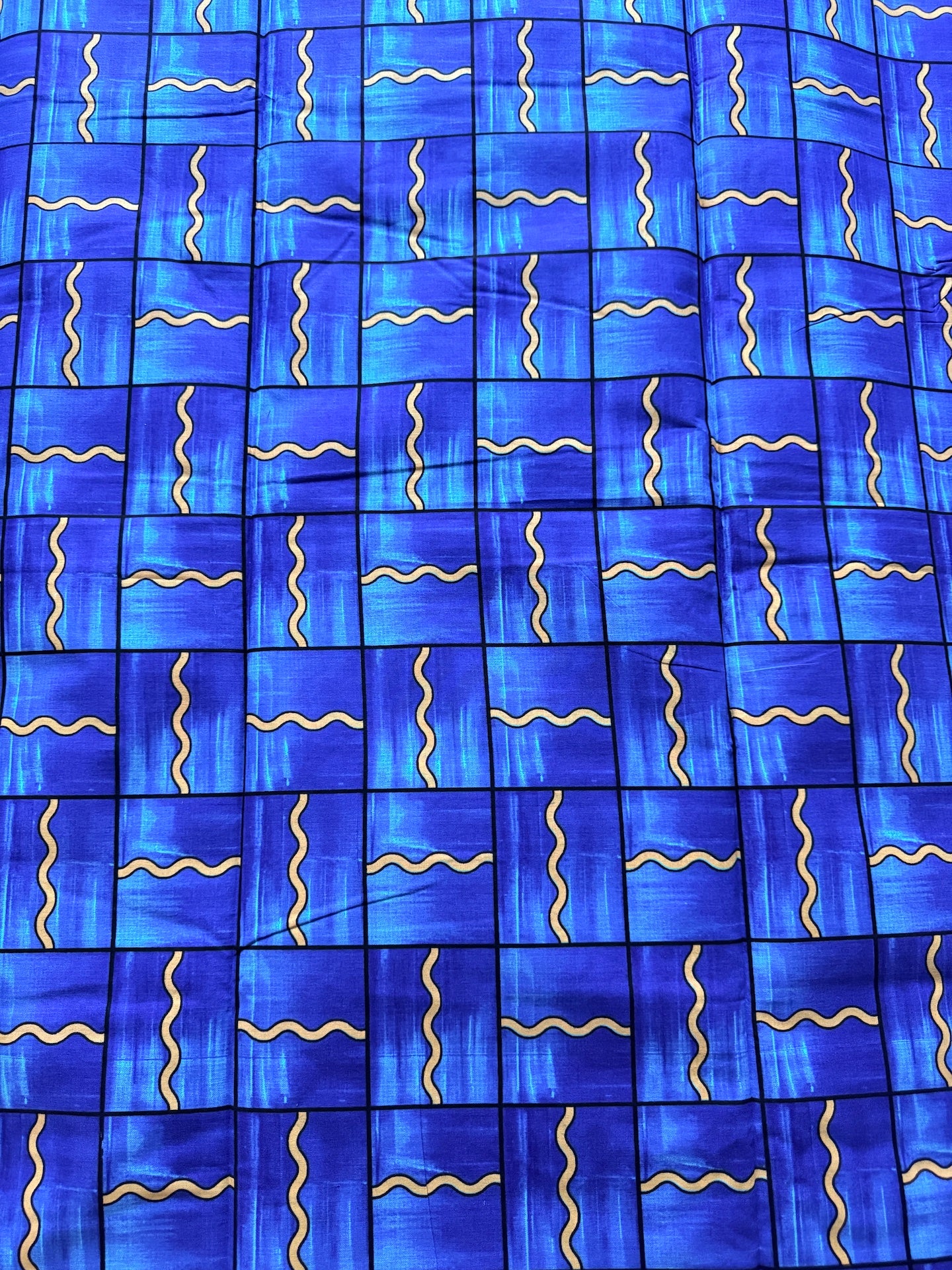 Blue fabric with wavy yellow lines pattern