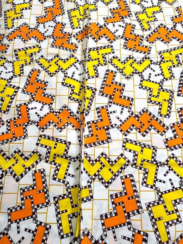 Patterned fabric with orange, yellow, and black geometric design on a white background