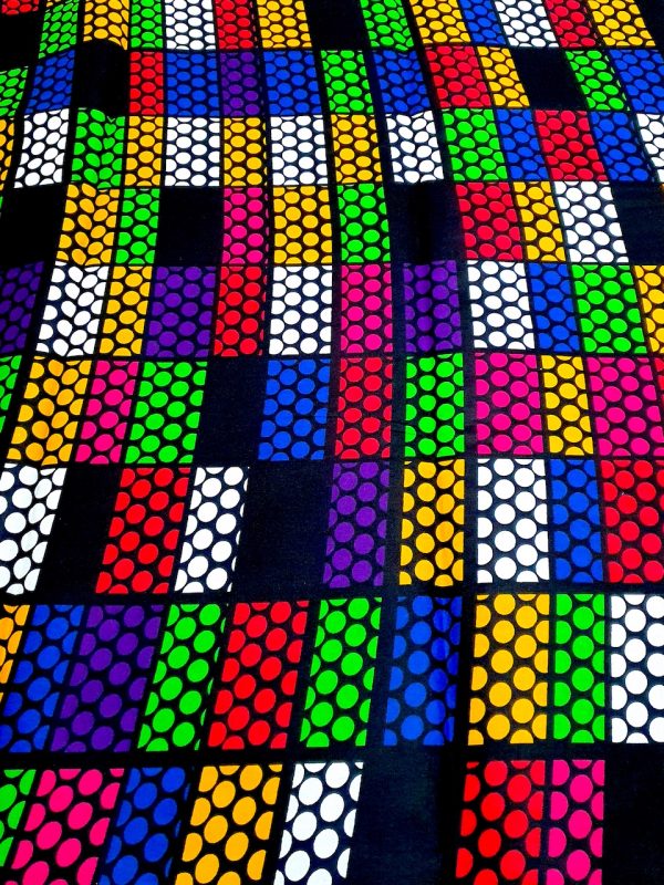 Colorful patterned fabric with geometric design on a black background