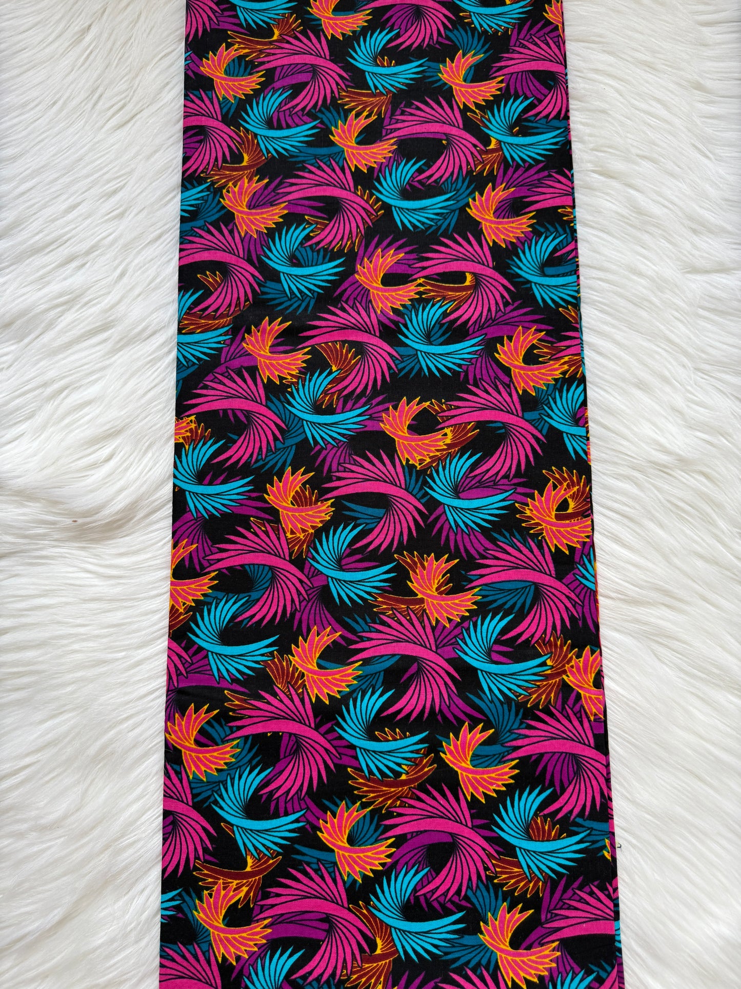 Colorful patterned tie on a white textured background