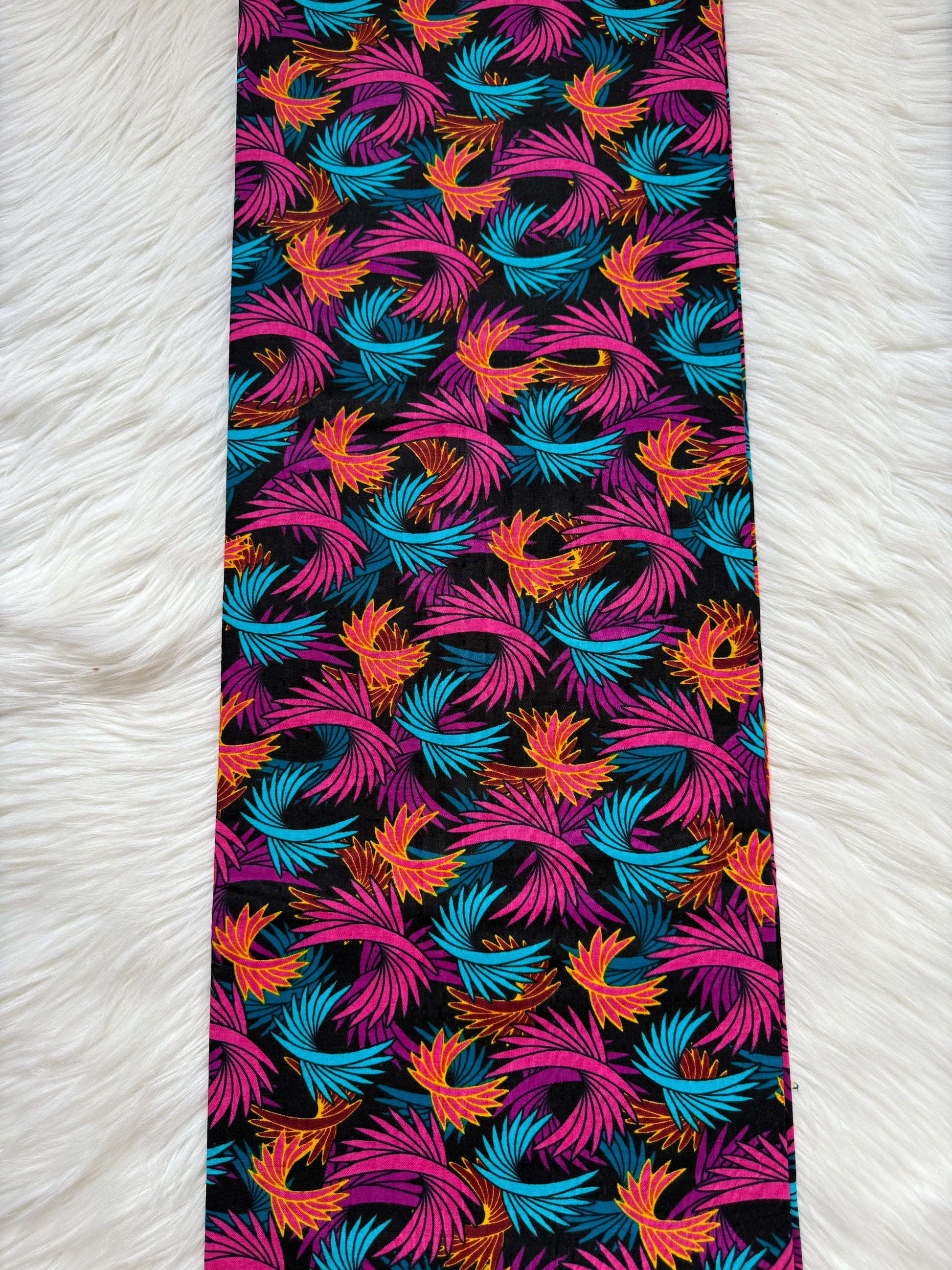 Colorful patterned tie on a white textured background