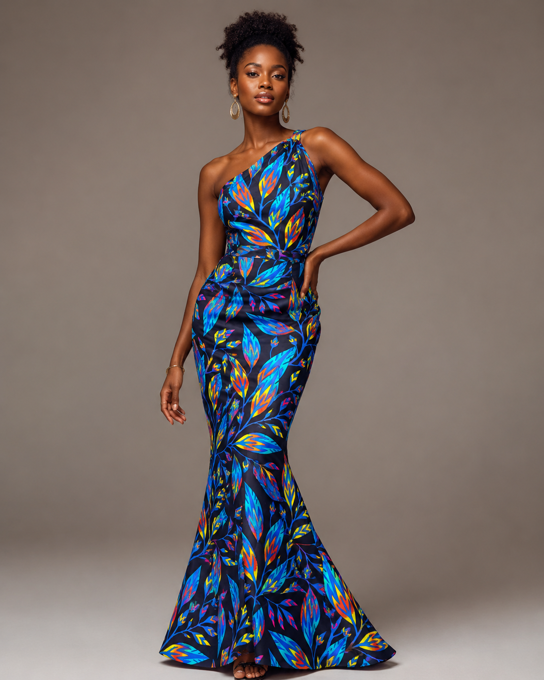 Woman wearing a colorful one-shoulder dress against a gray background