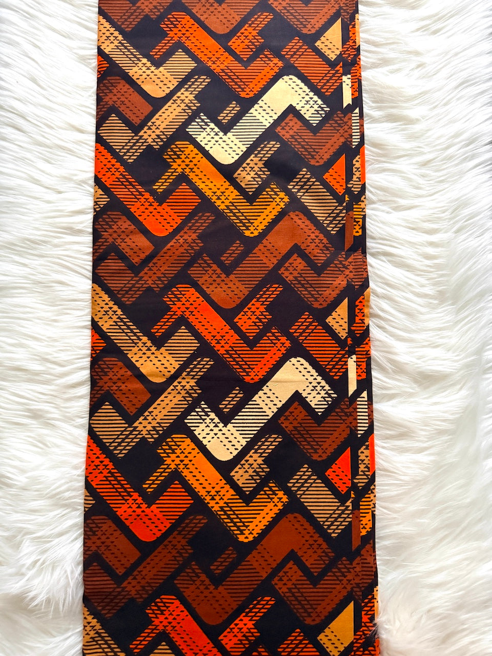Tie with geometric pattern on a white textured background