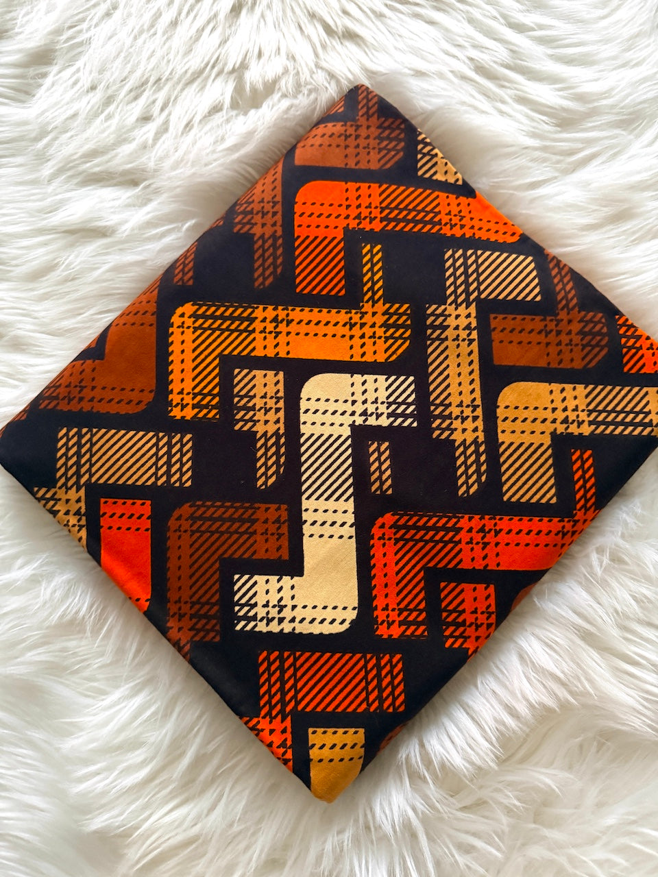 Patterned fabric square on a white fluffy surface
