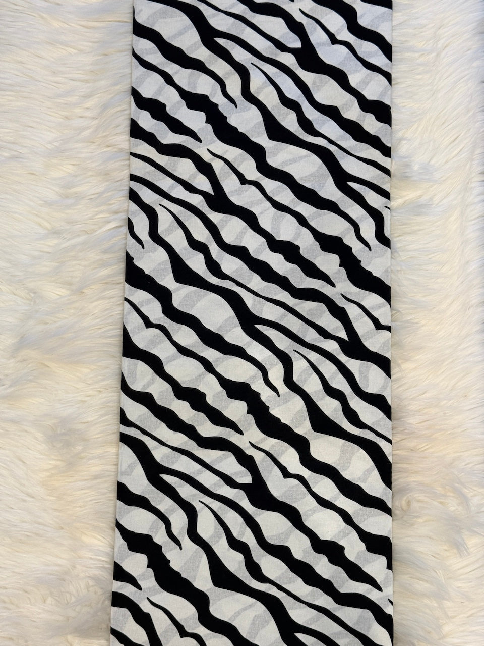 Black and white striped fabric on a textured white background