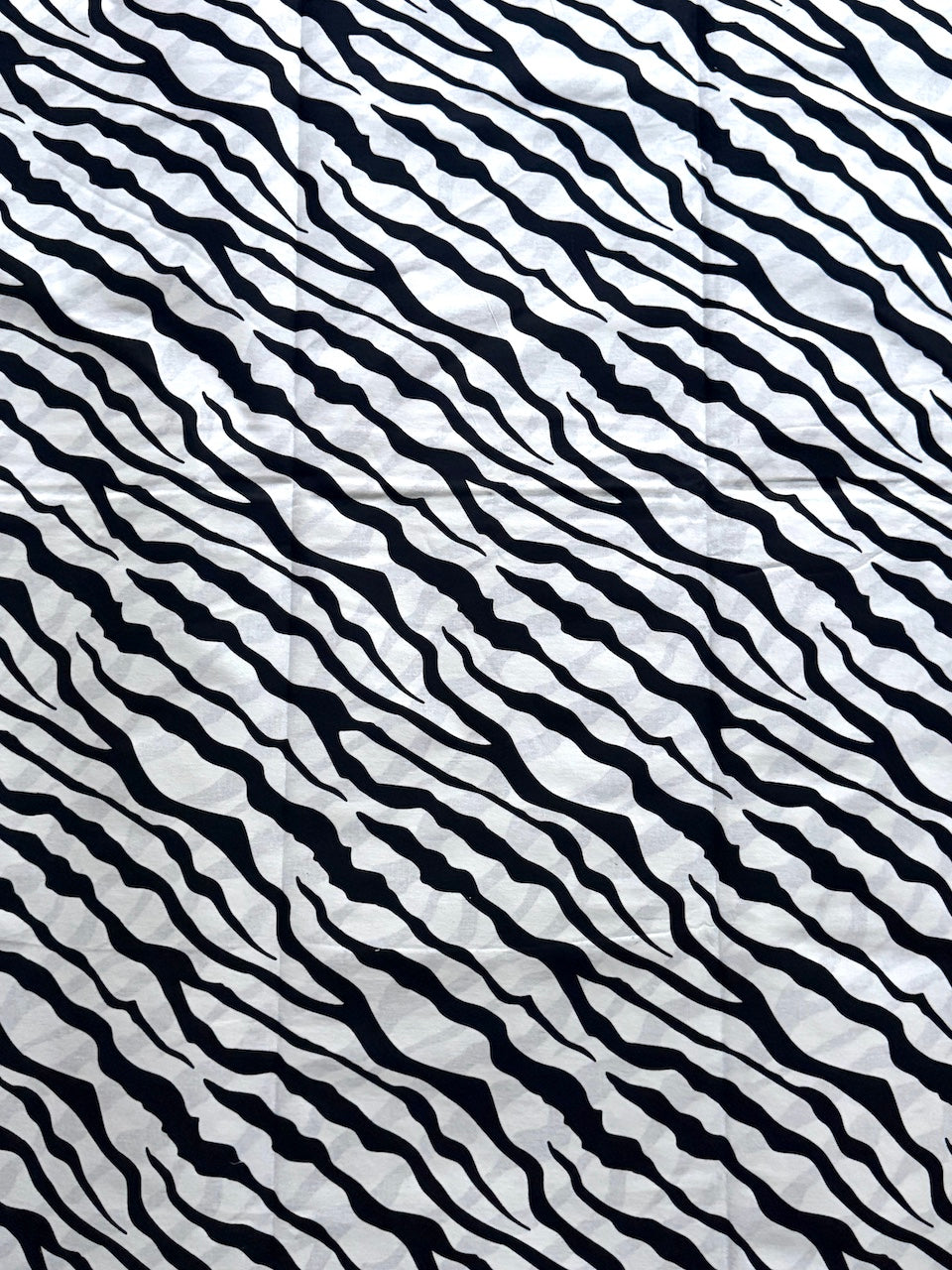 Black and white wavy pattern on a textured background
