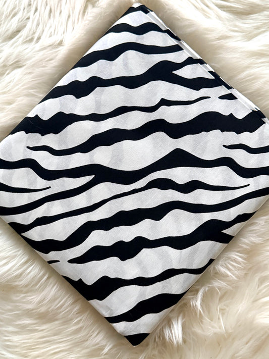 Black and white striped fabric on a fluffy white surface