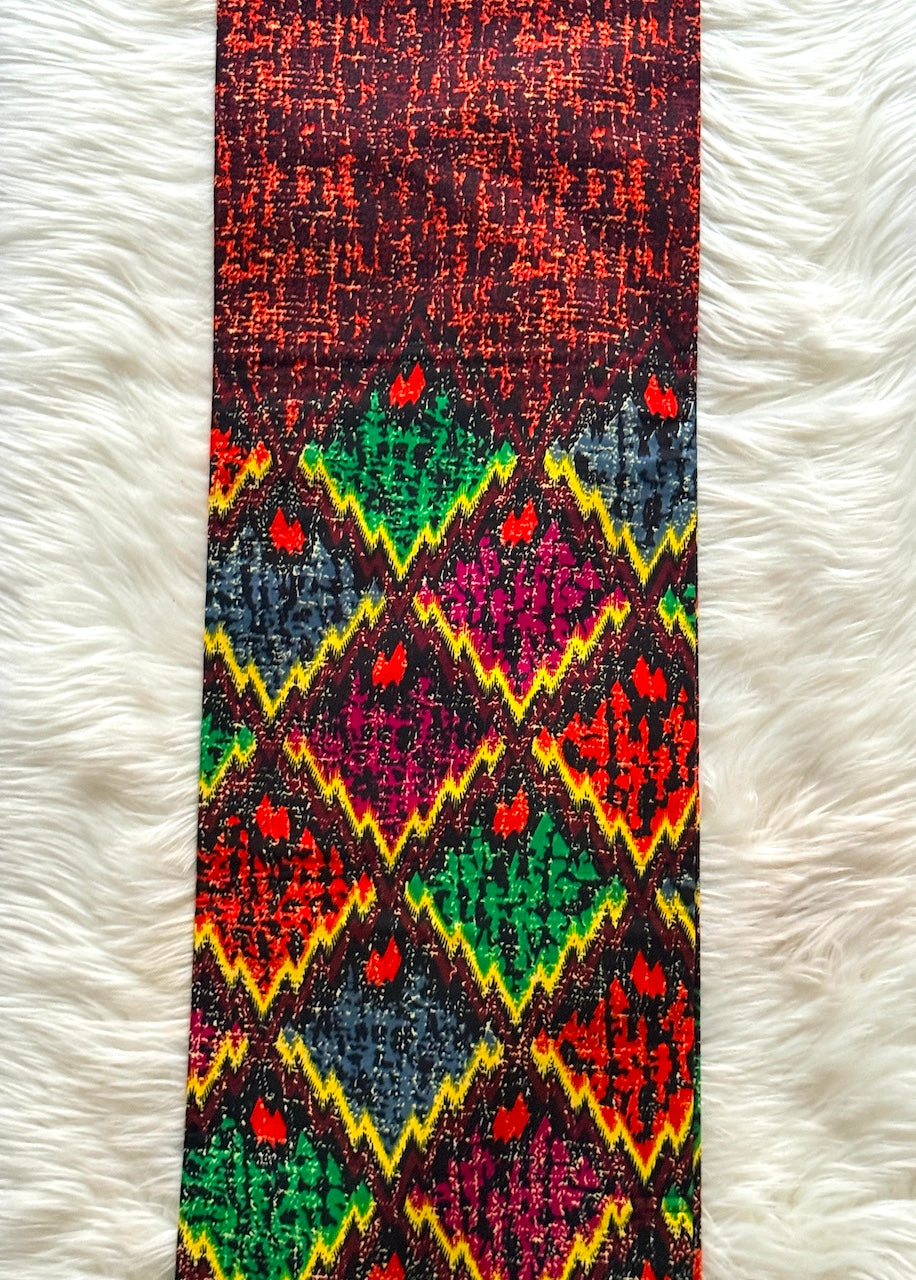 Colorful patterned belt on a white fur background