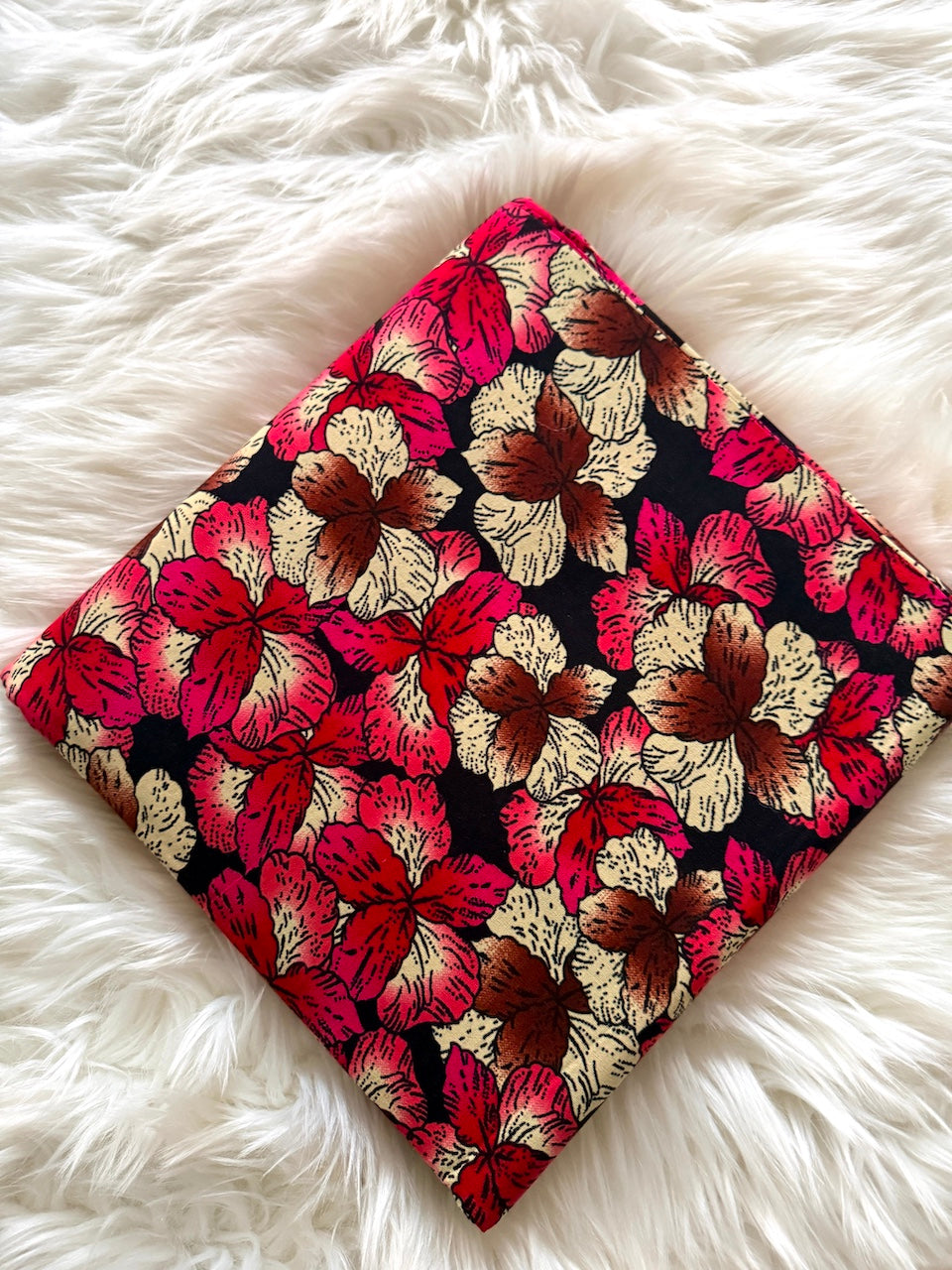 Floral patterned fabric on a fluffy white surface
