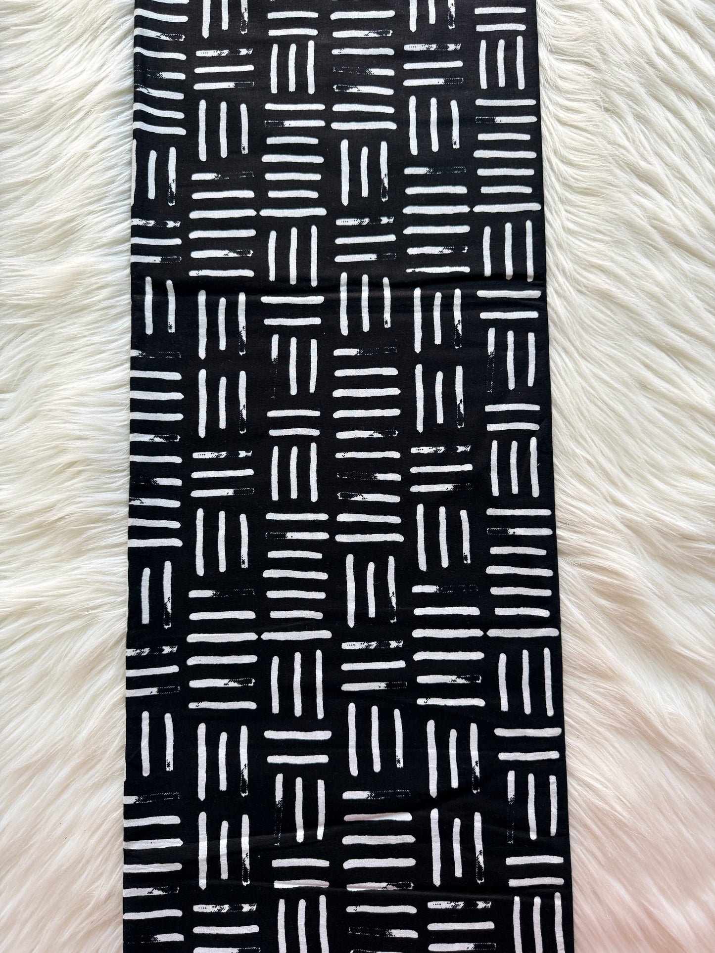 Black and white patterned band on a fluffy white background