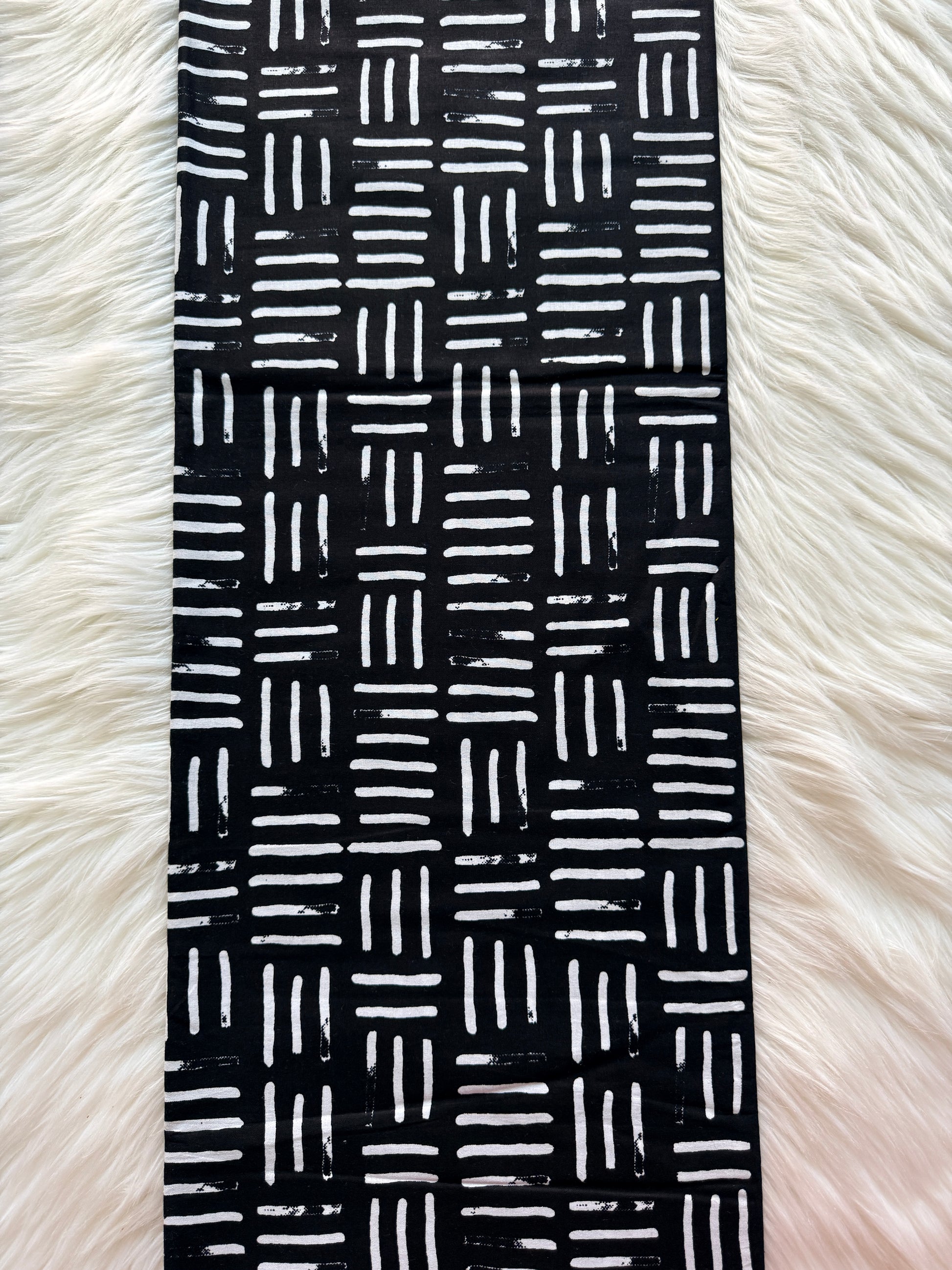 Black and white patterned band on a fluffy white background
