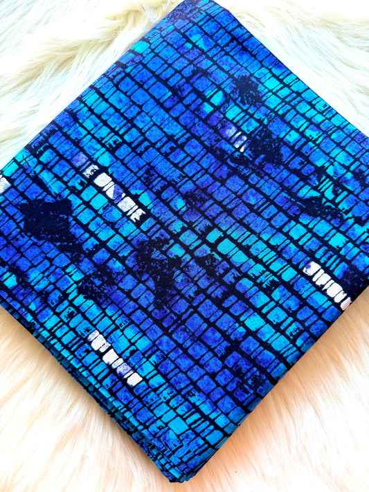 Blue patterned fabric on a white fur surface
