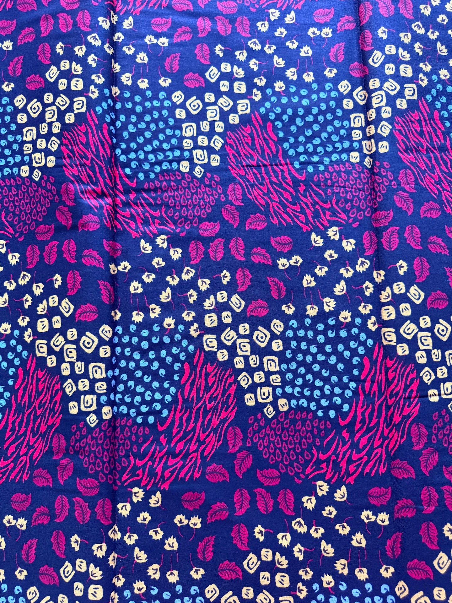 Patterned fabric with blue, pink, and white design on a blue background