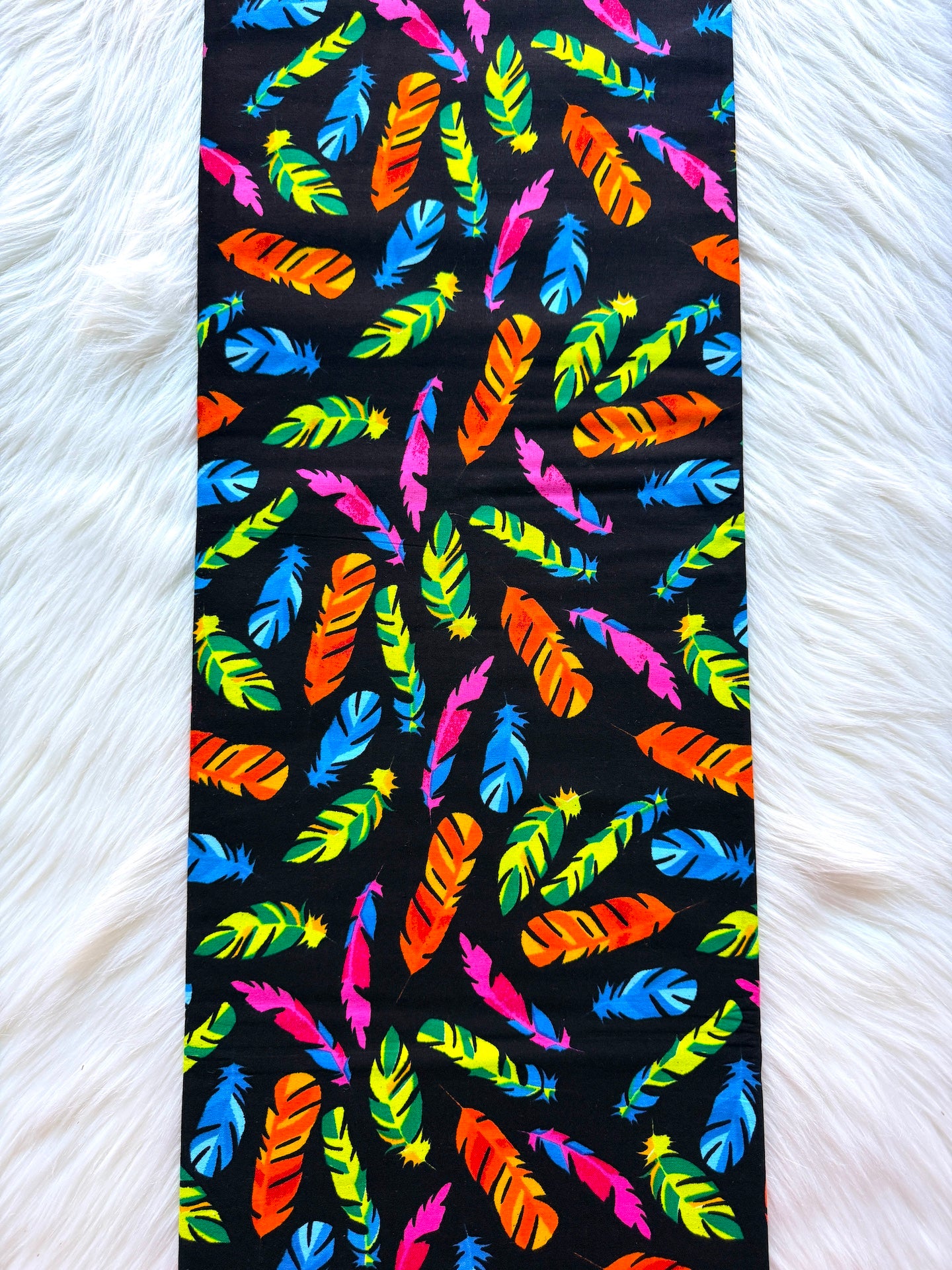 Colorful feather pattern on a black background