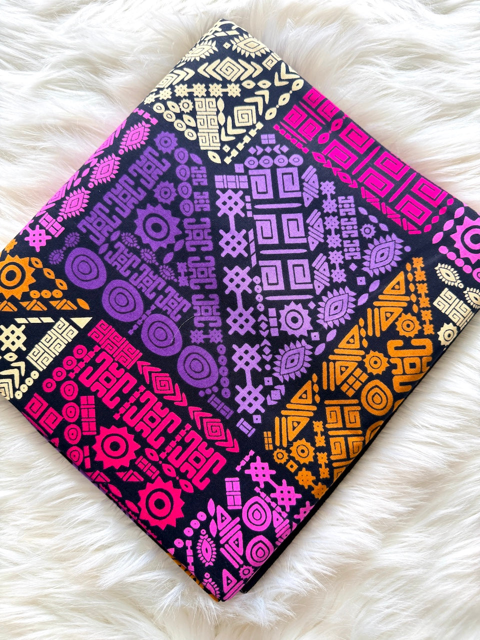Colorful patterned fabric on a white fluffy surface