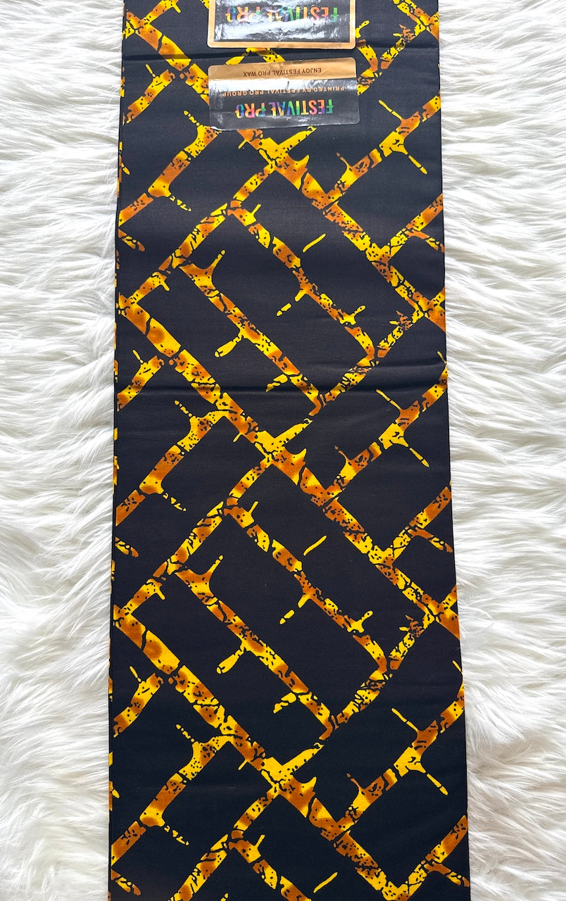 Black tie with gold pattern on a white textured surface
