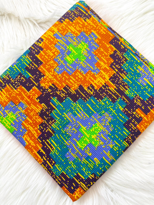 Colorful woven fabric with geometric pattern on a white textured background