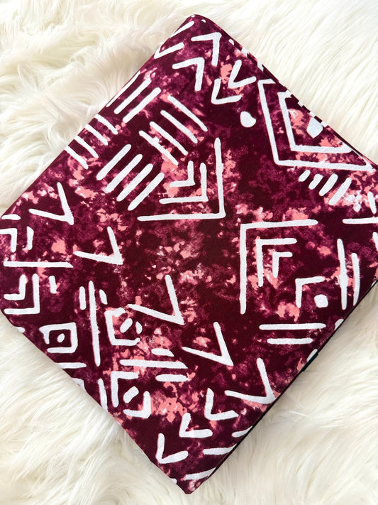 Fabric with geometric pattern on a white textured surface