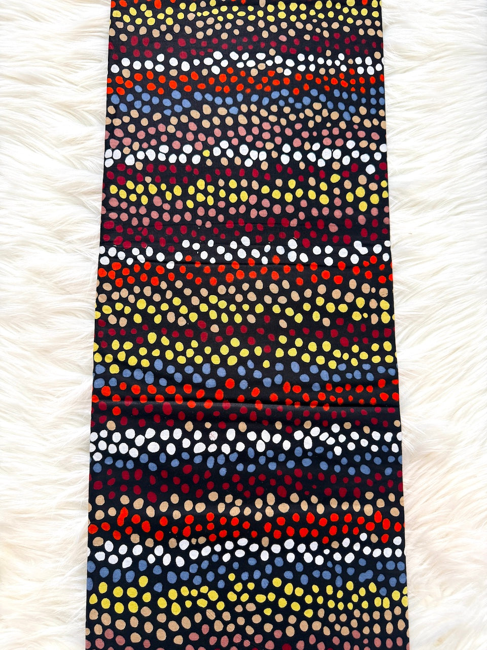 Colorful patterned fabric on a textured white background