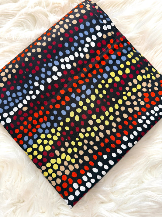 Colorful polka dot fabric on a white fluffy surface