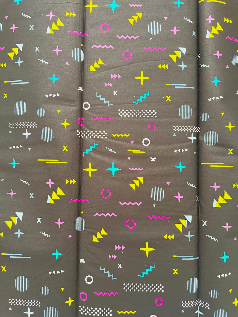 Textile with colorful geometric pattern on a gray background
