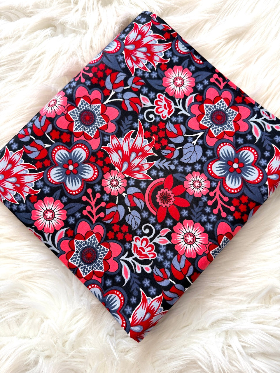 Floral-patterned fabric on a white fluffy surface