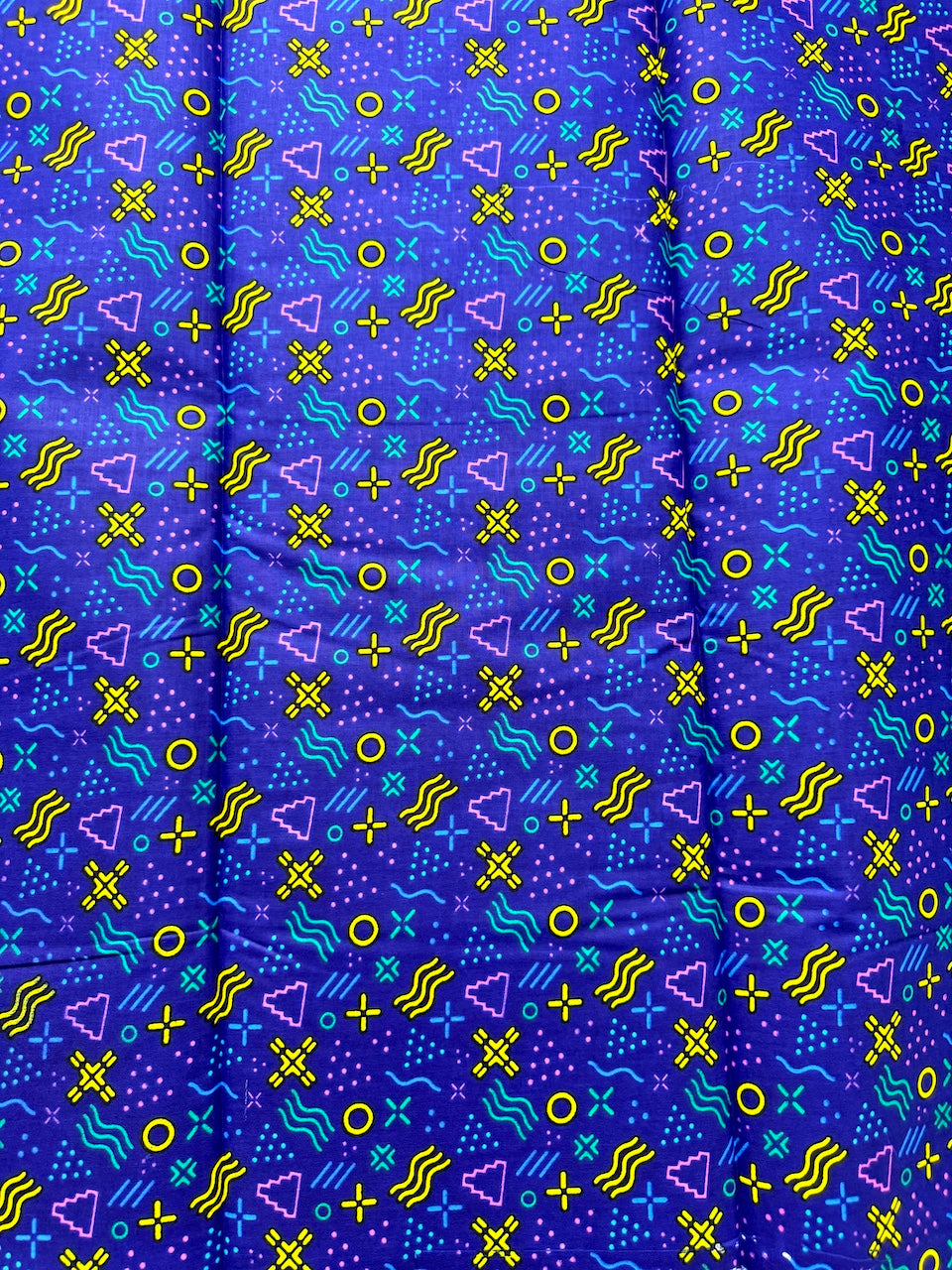 Patterned fabric with geometric shapes on a blue background