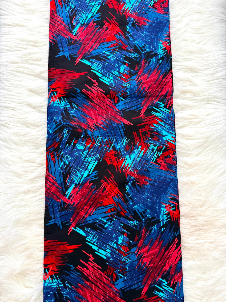 Colorful abstract patterned tie on a white textured background