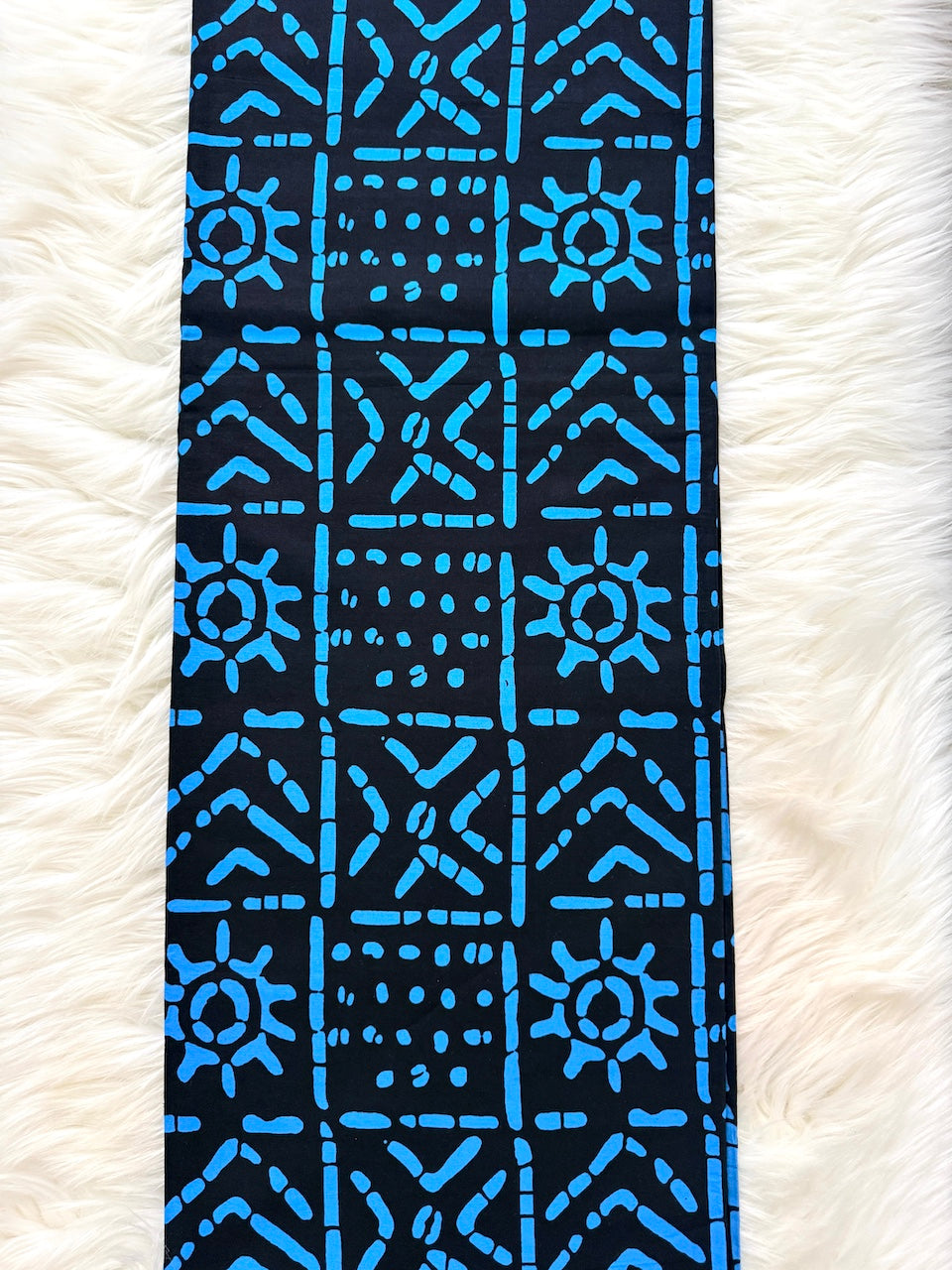 Blue patterned fabric on a white textured background