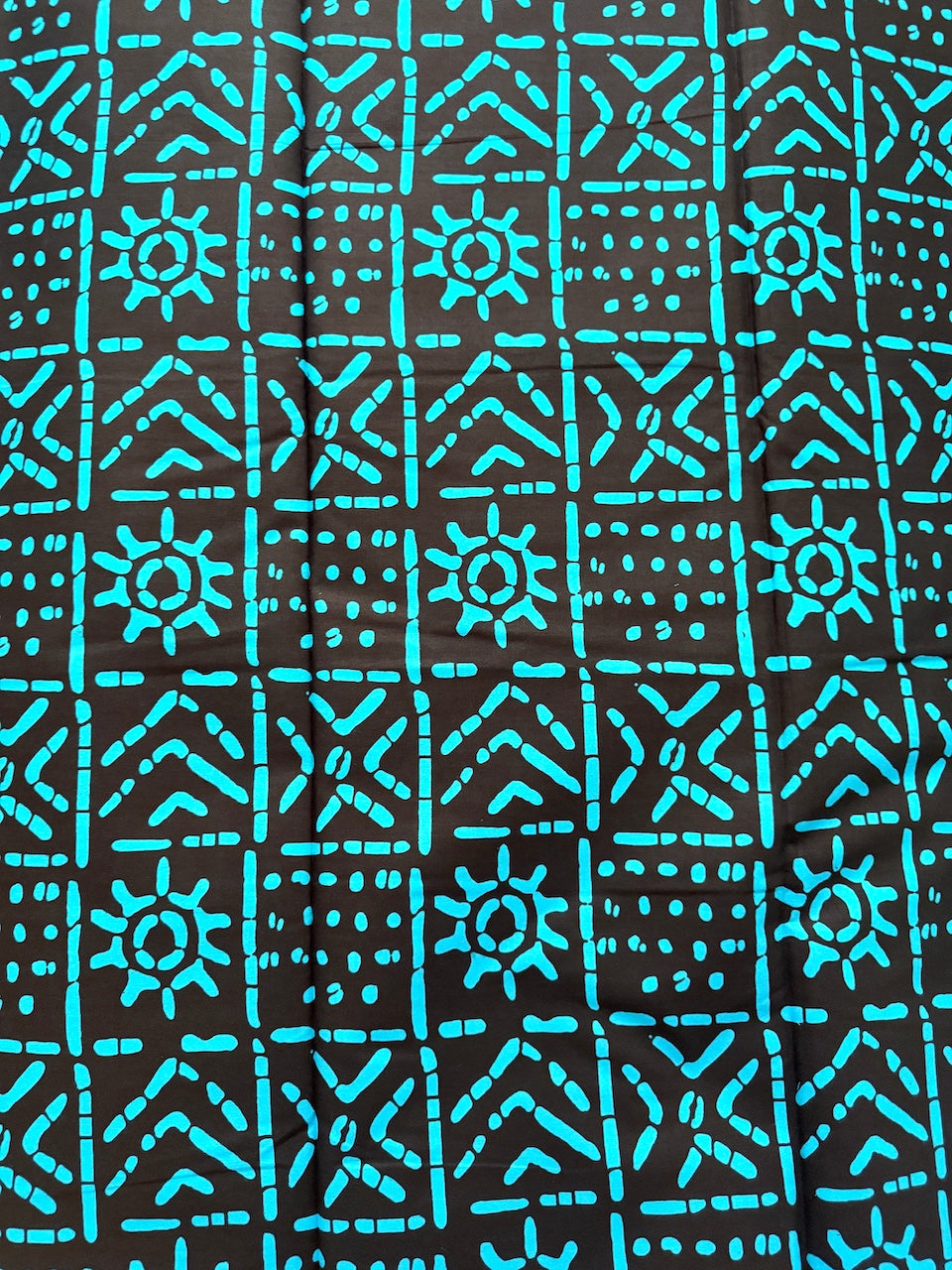 Patterned fabric with blue geometric design on black background