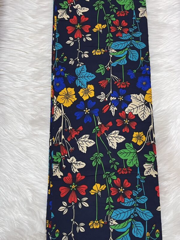 Floral-patterned tie on a textured white background