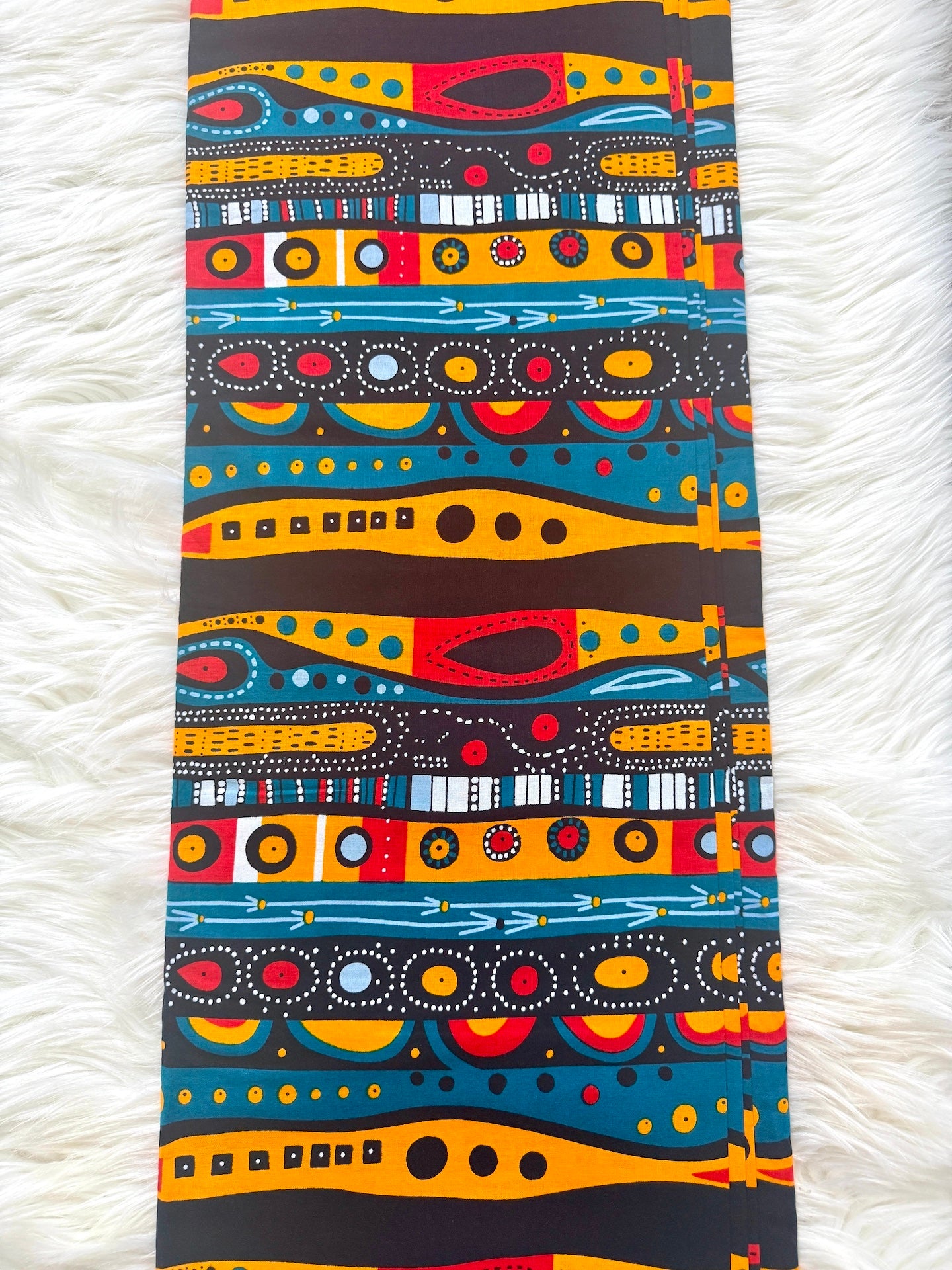 Colorful abstract patterned fabric on a white textured background