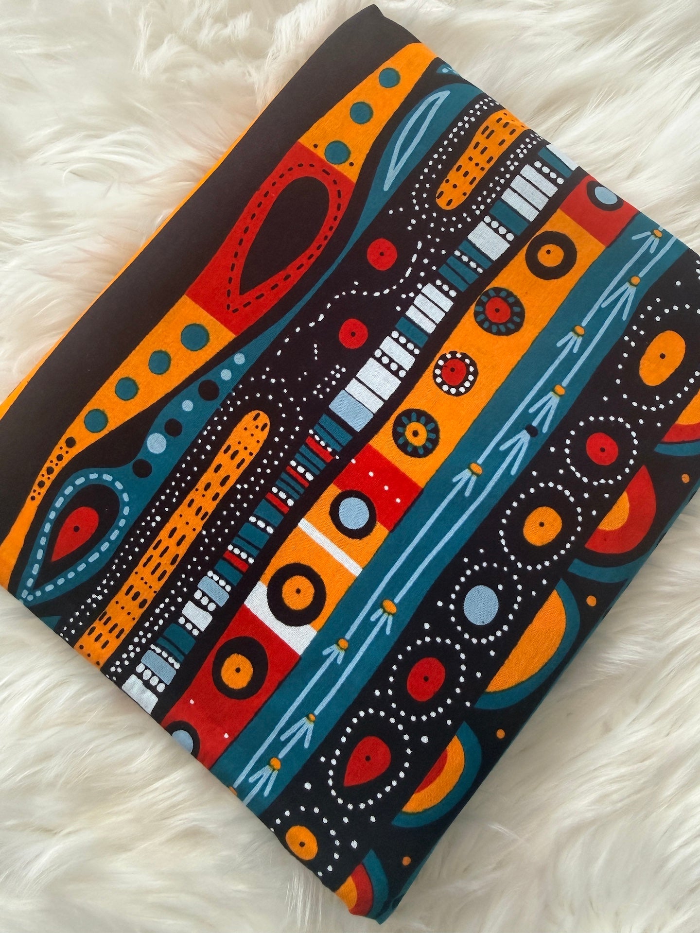 Colorful patterned fabric on a white fluffy surface