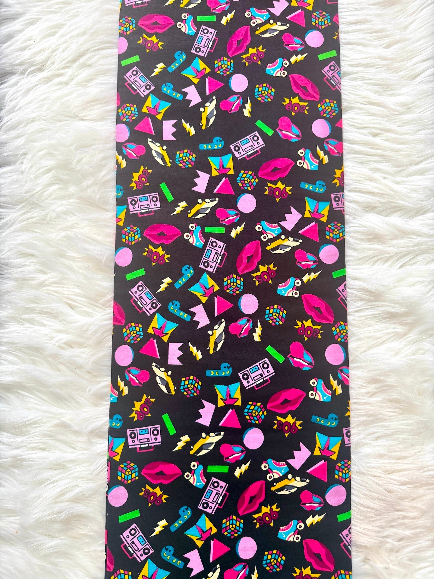 Colorful patterned tie on a white fluffy surface