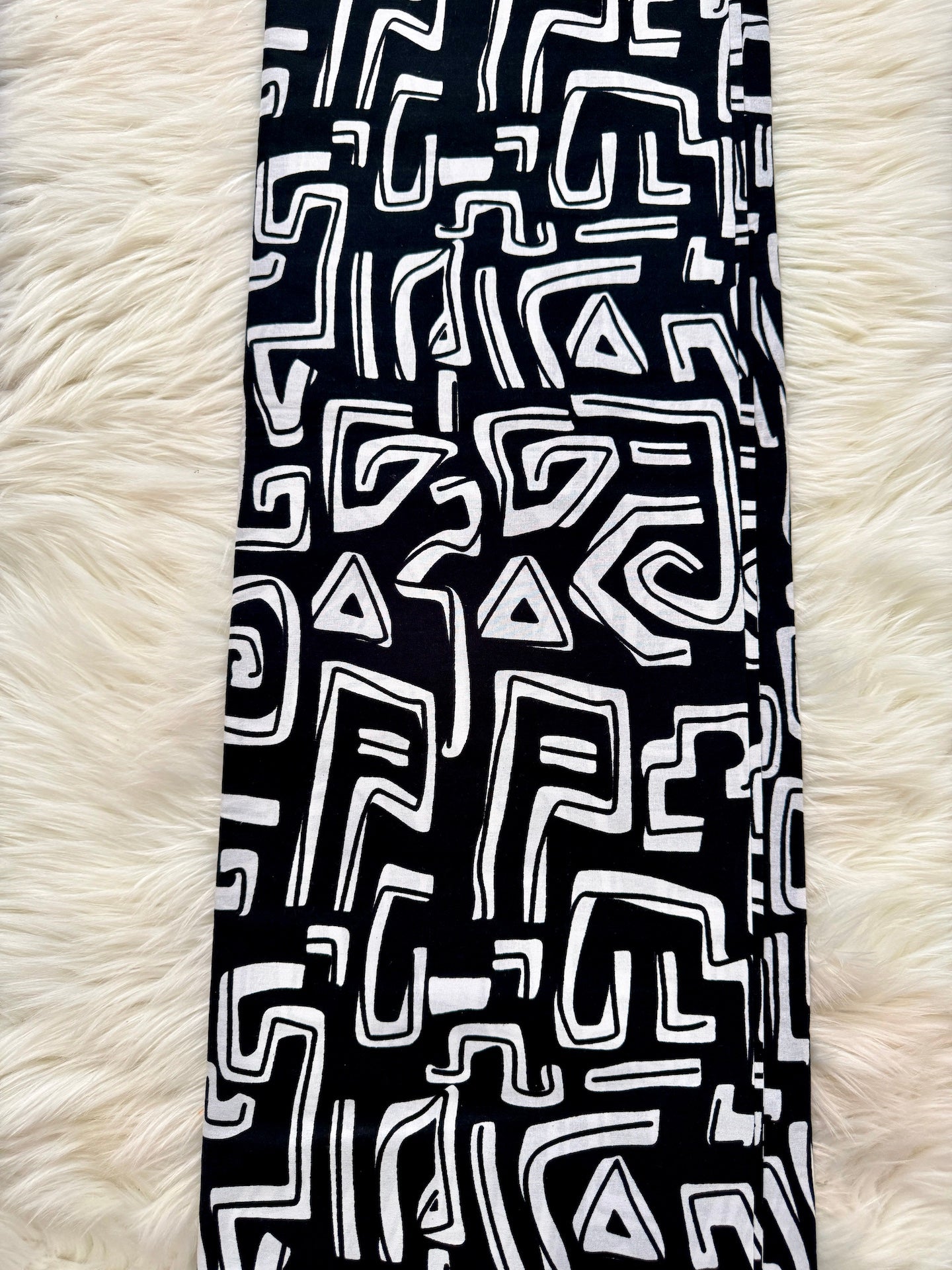 Black and white patterned fabric on a fluffy white surface