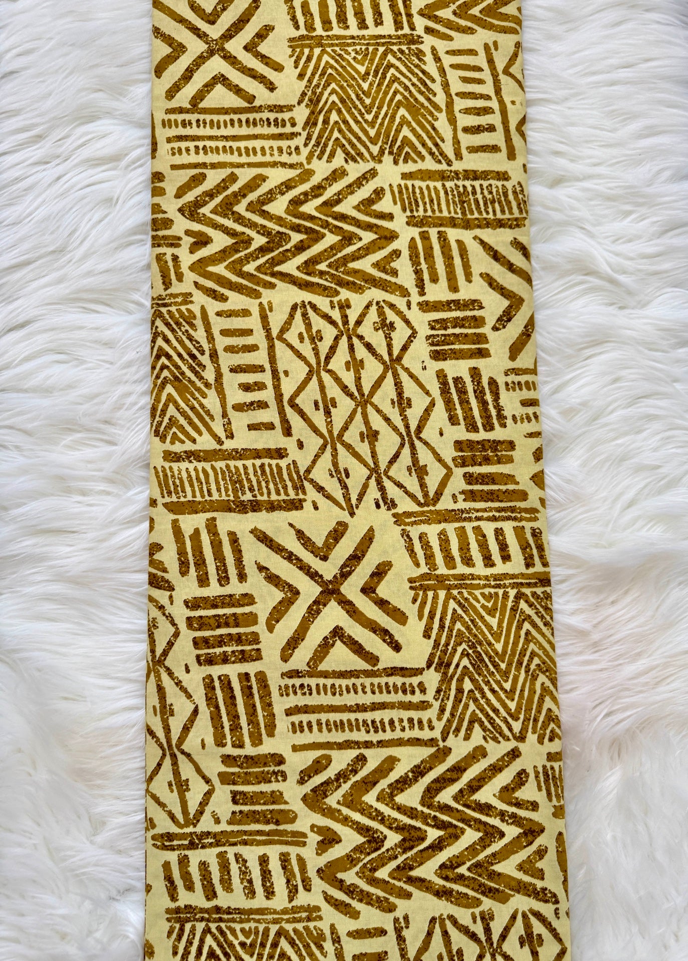 Towel with geometric pattern on a white fluffy surface