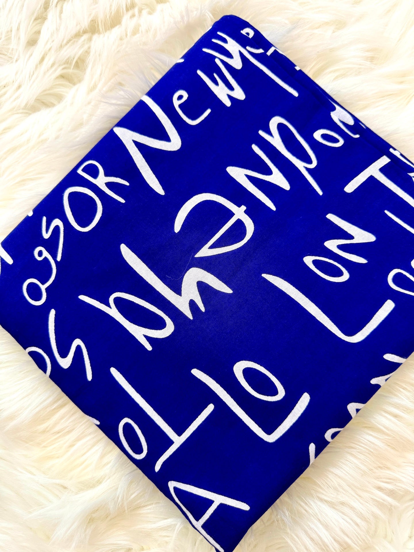 Blue square with white text on a fluffy white background