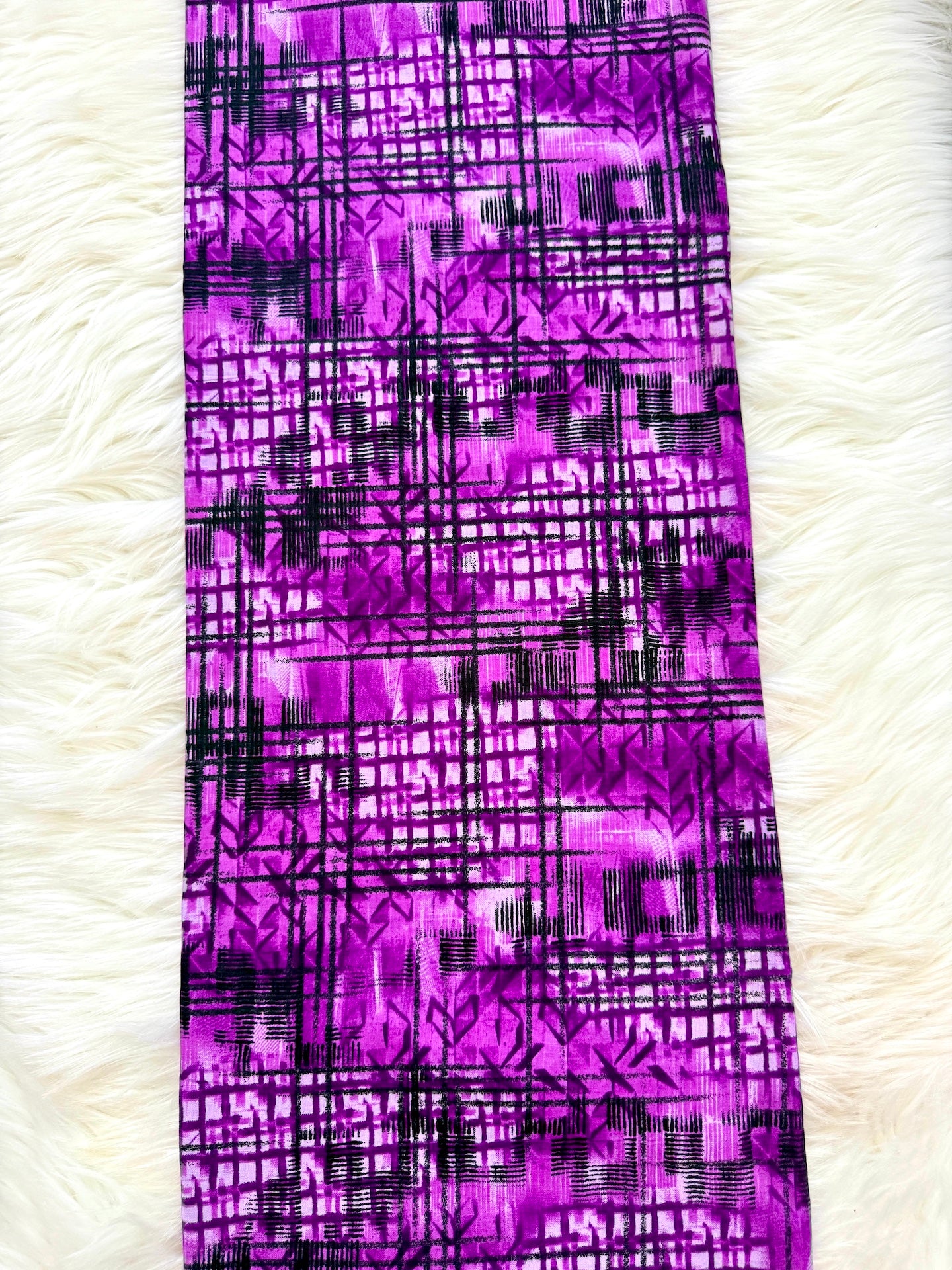 Purple fabric with black geometric pattern on a white background