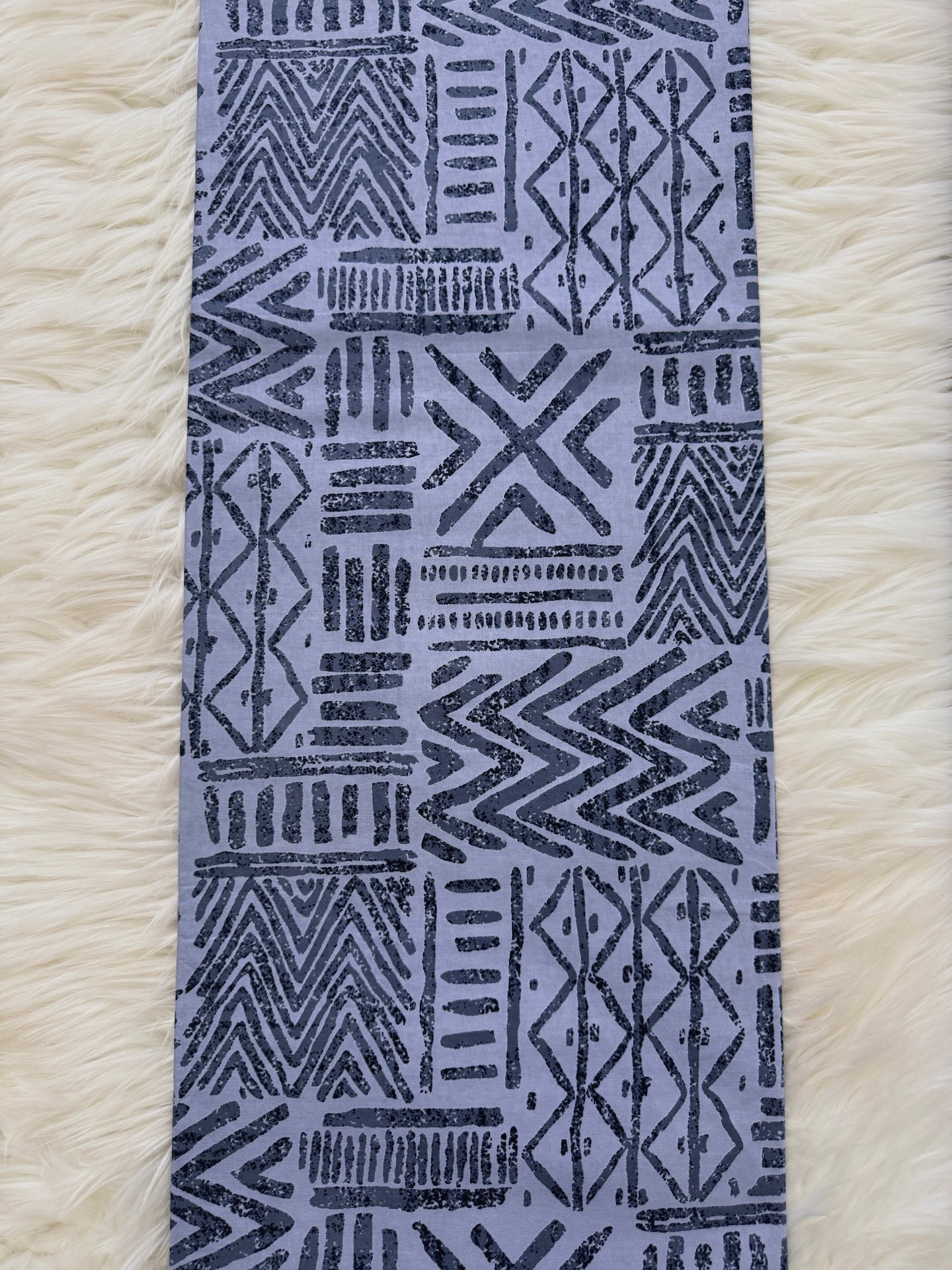 Textile with geometric pattern on a white textured background