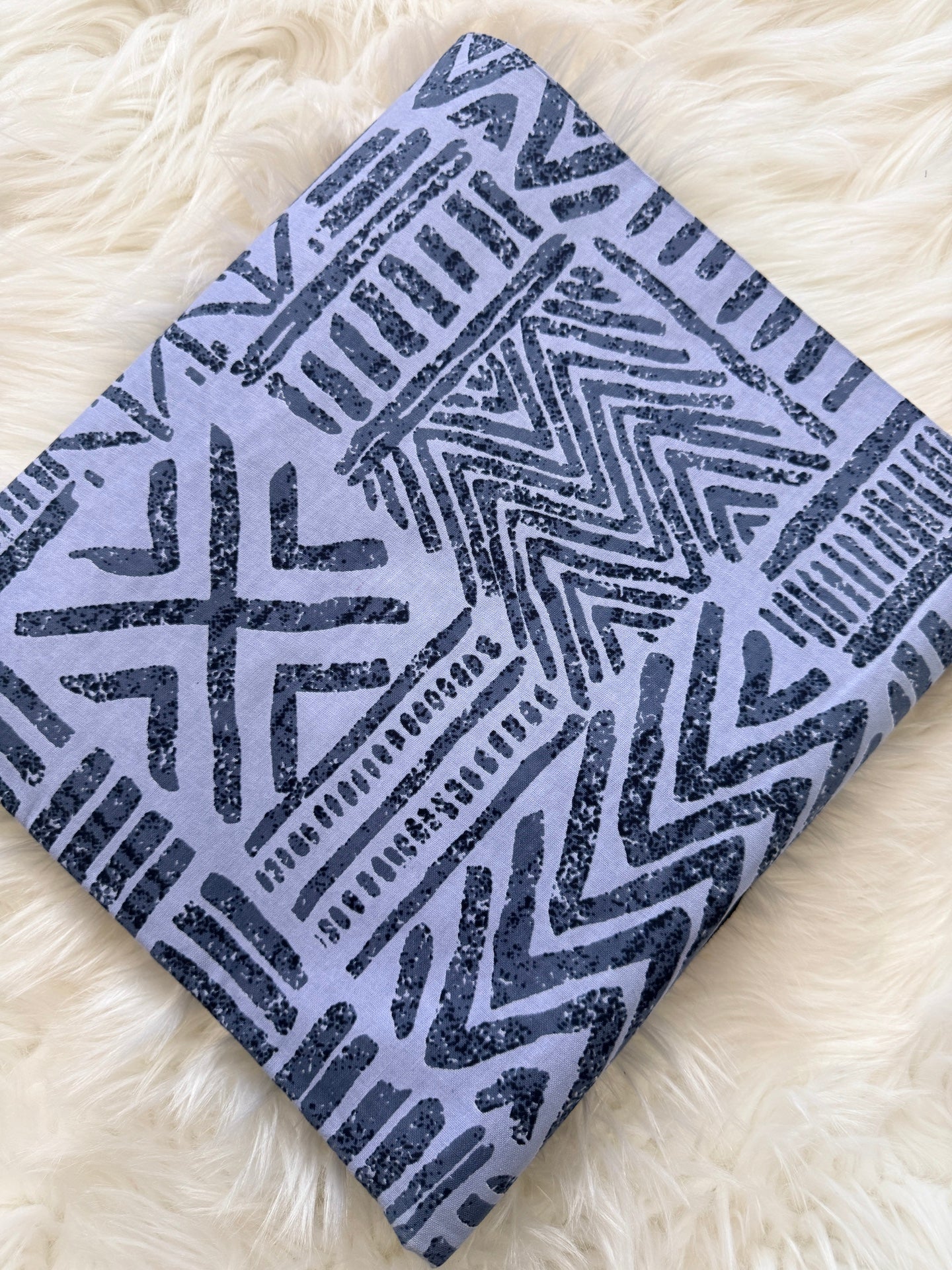 Notebook with geometric pattern on a fluffy white surface